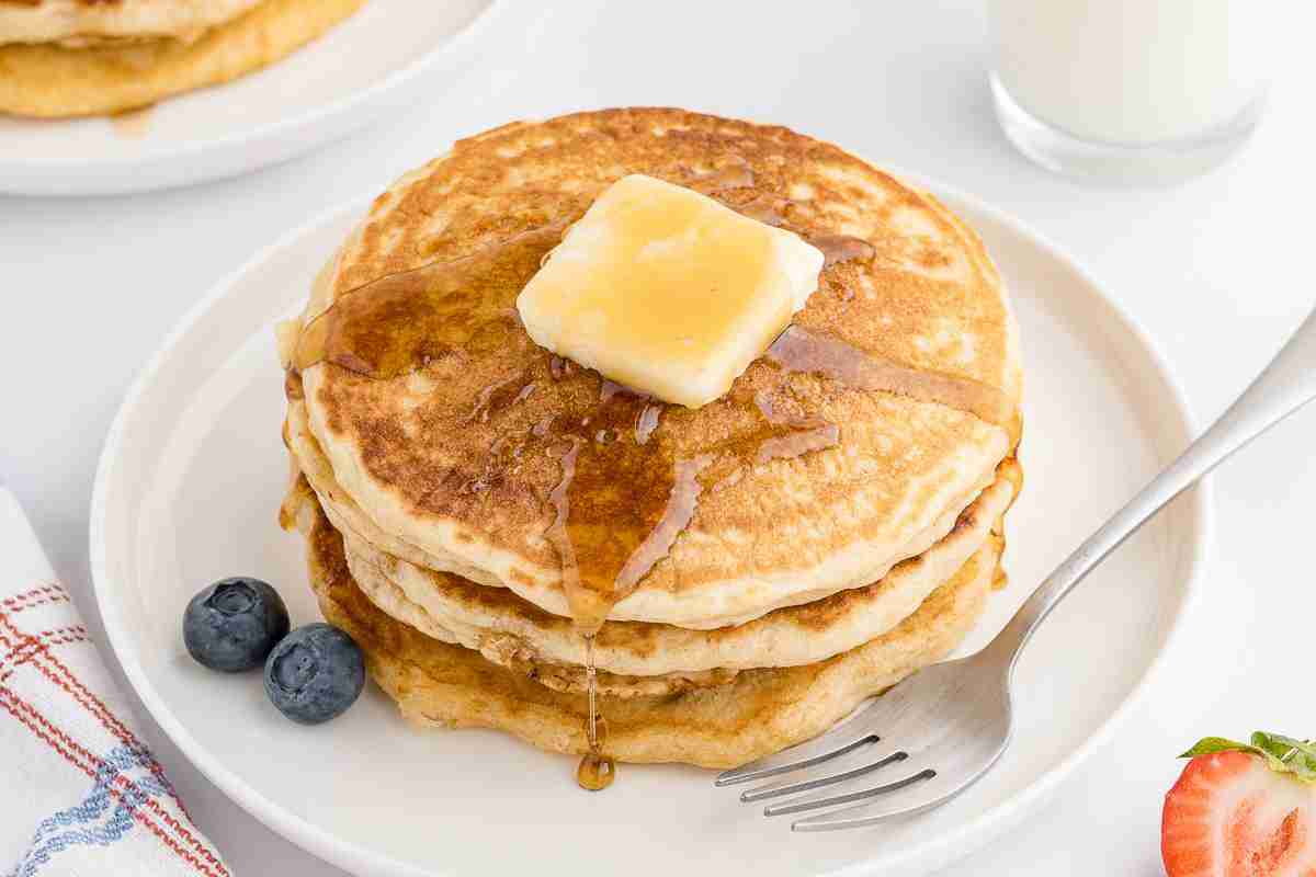 A stack of fresh milled pancakes with butter and syrup
