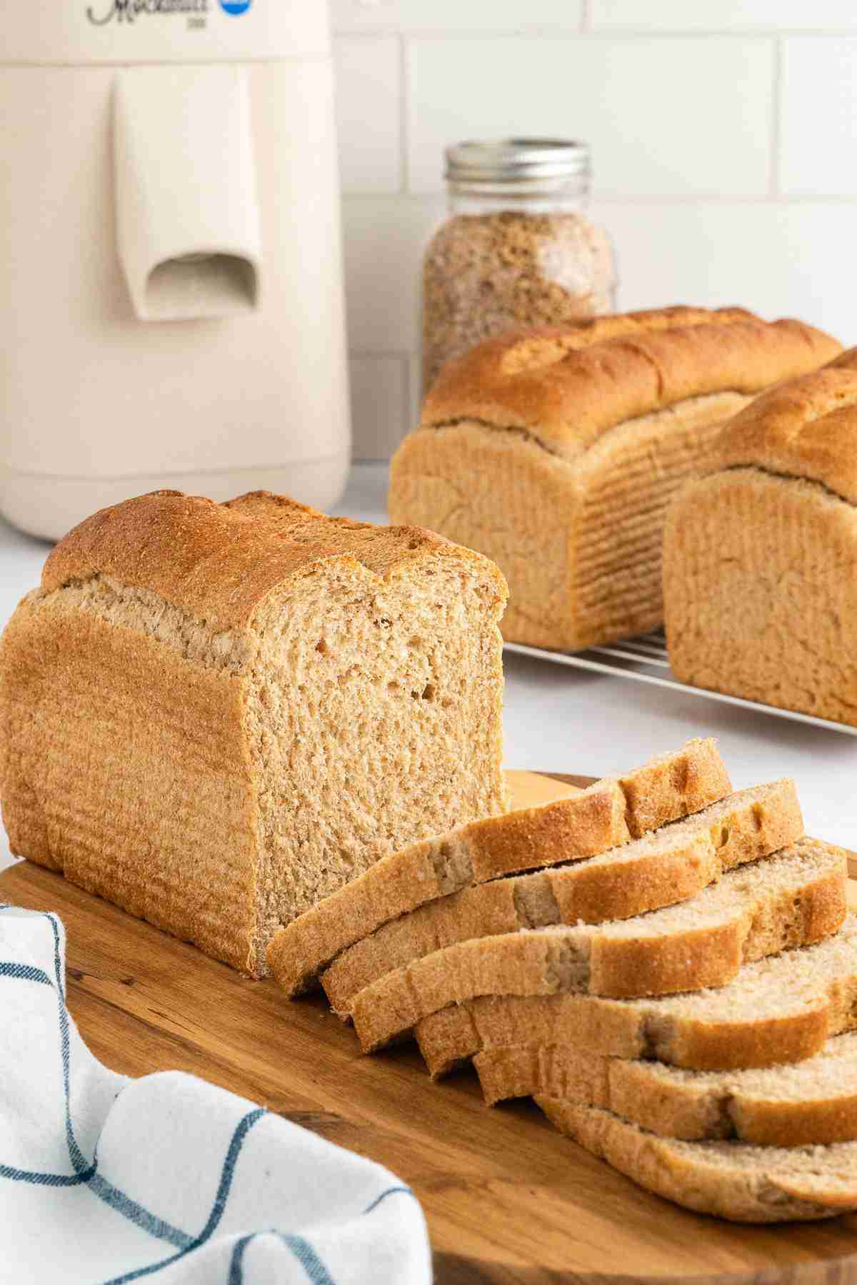 fresh milled flour sandwich bread loaf with mill in background