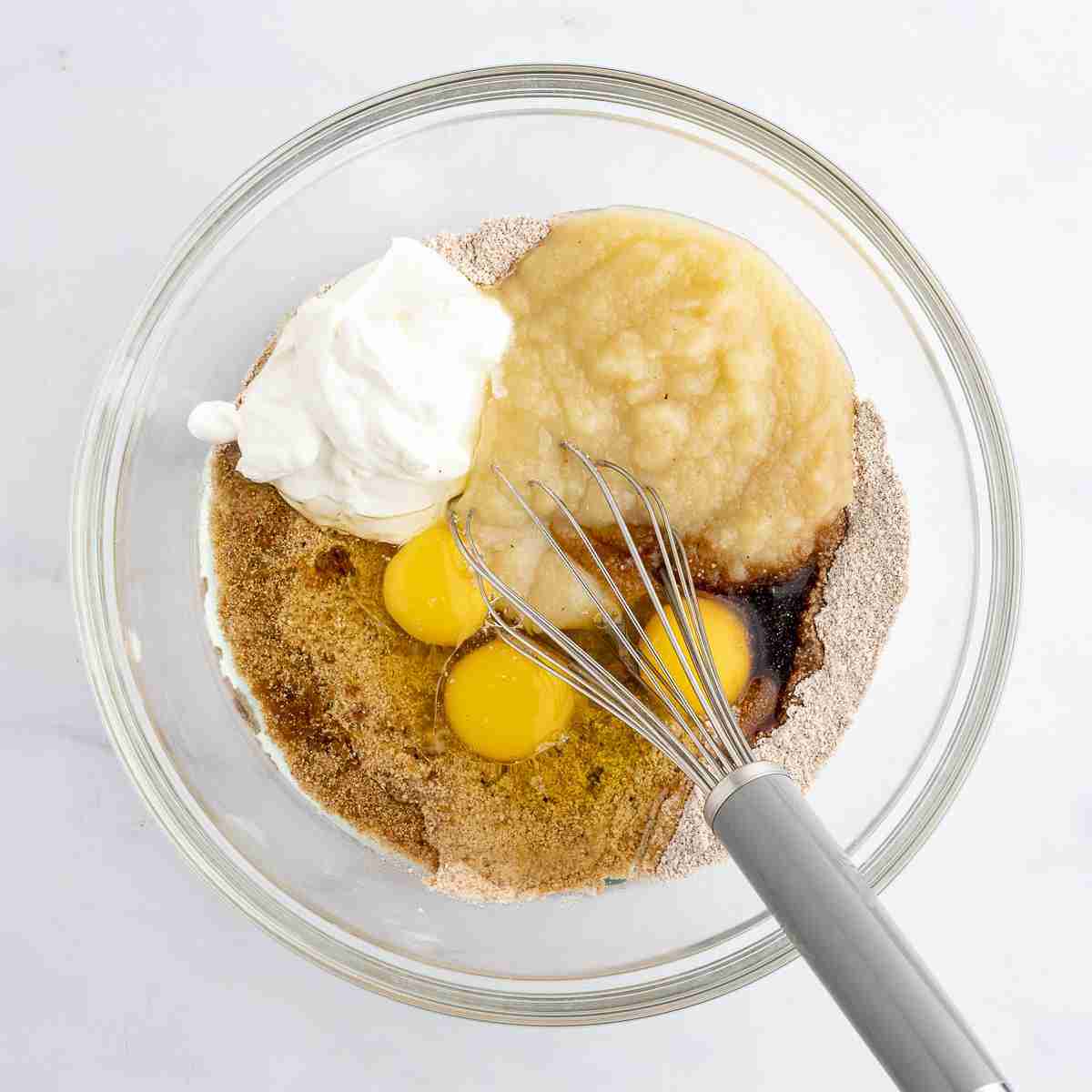 mixing bowl showing wet ingredients added to dry for apple oatmeal cake