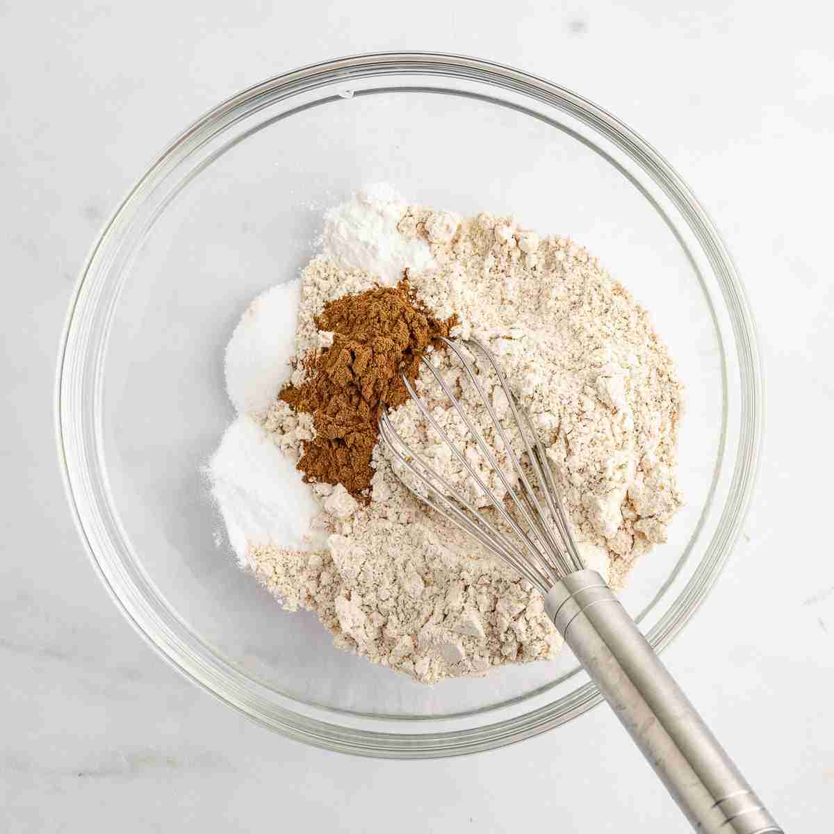 mixing bowl with dry ingredients for oatmeal raisin cookies