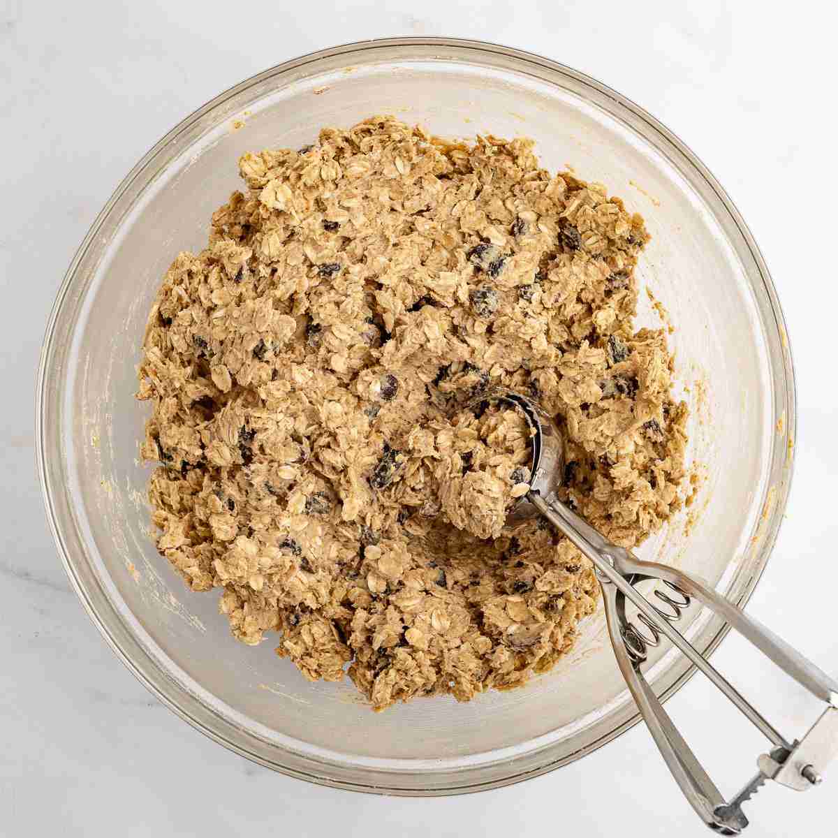 mixing bowl showing finished oatmeal raisin dough