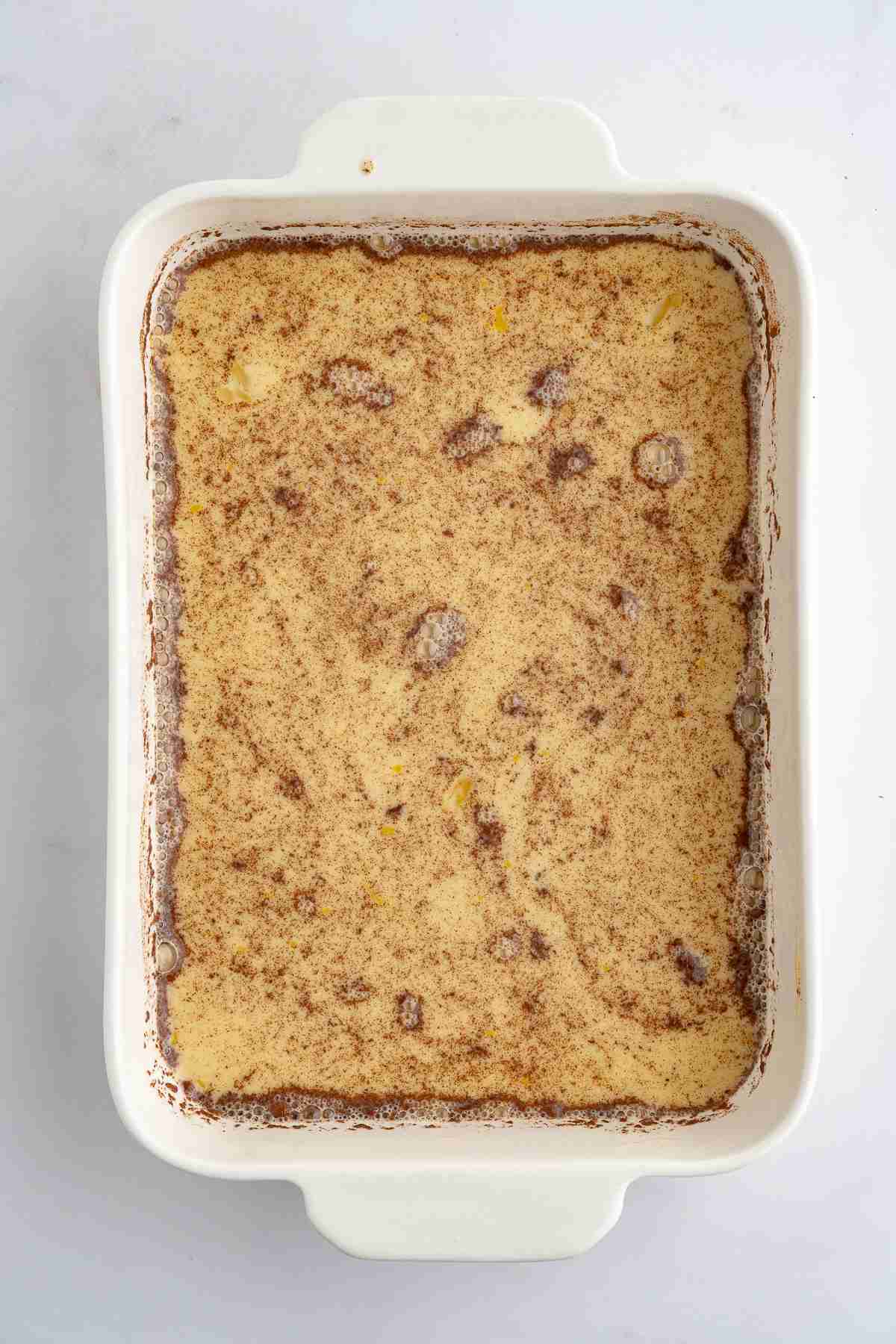 casserole dish showing egg mixture for banana bread french toast