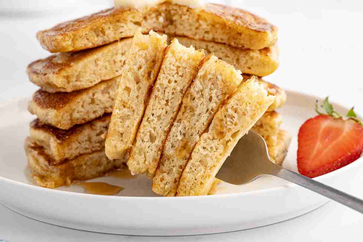 a stack of fresh milled buttermilk pancakes with bite shot on fork