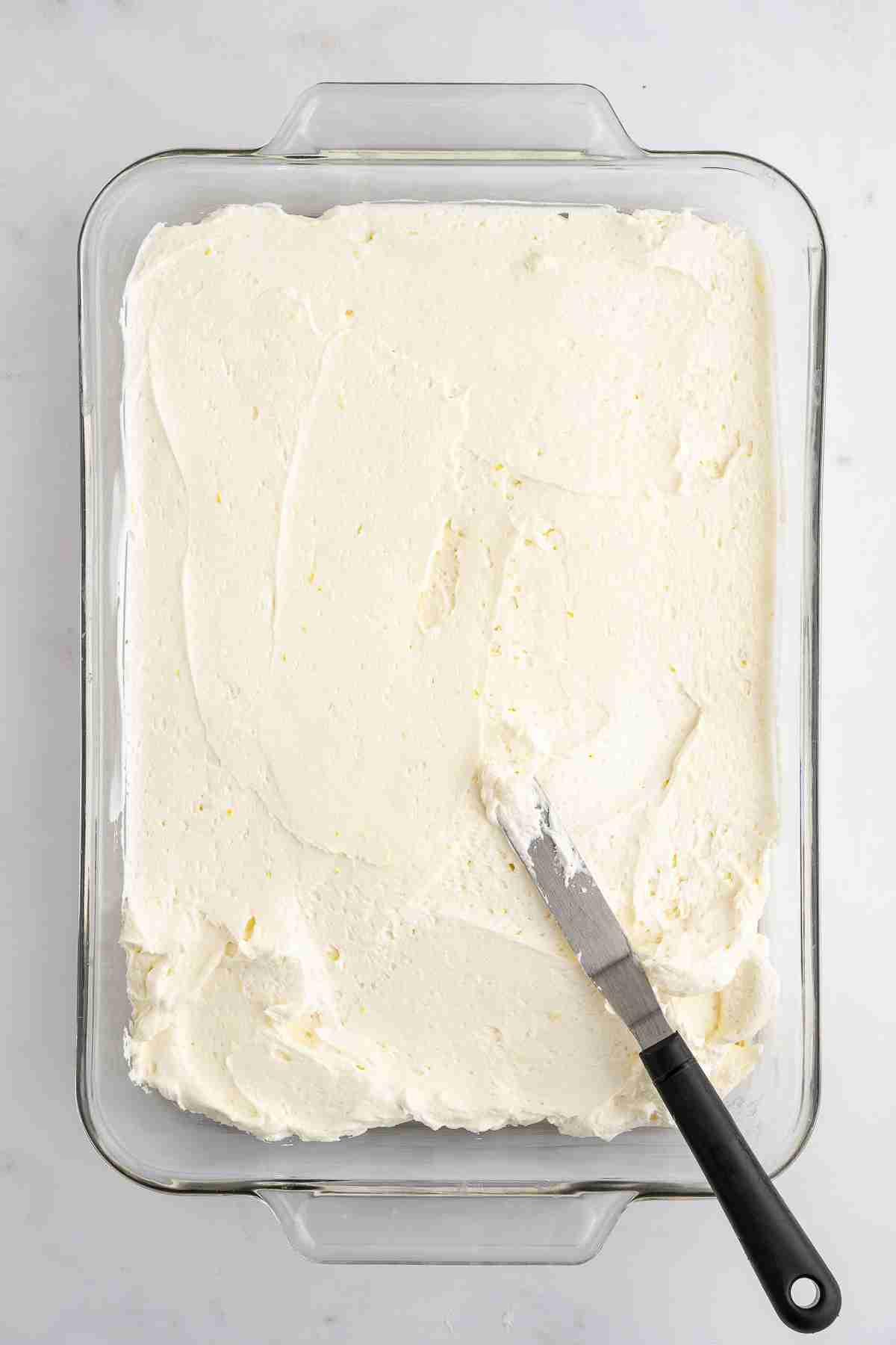 spreading the cheesecake layer over crust for lemon lush