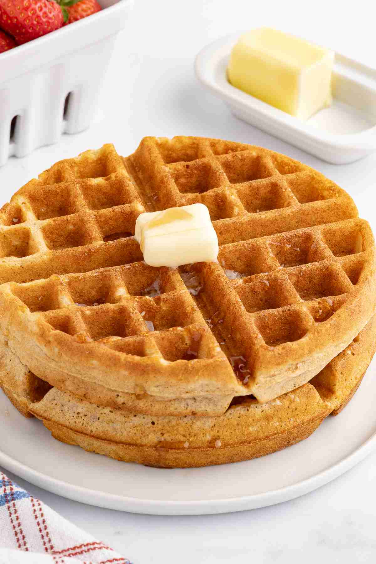 fresh milled flour waffles with butter and syrup on white plate