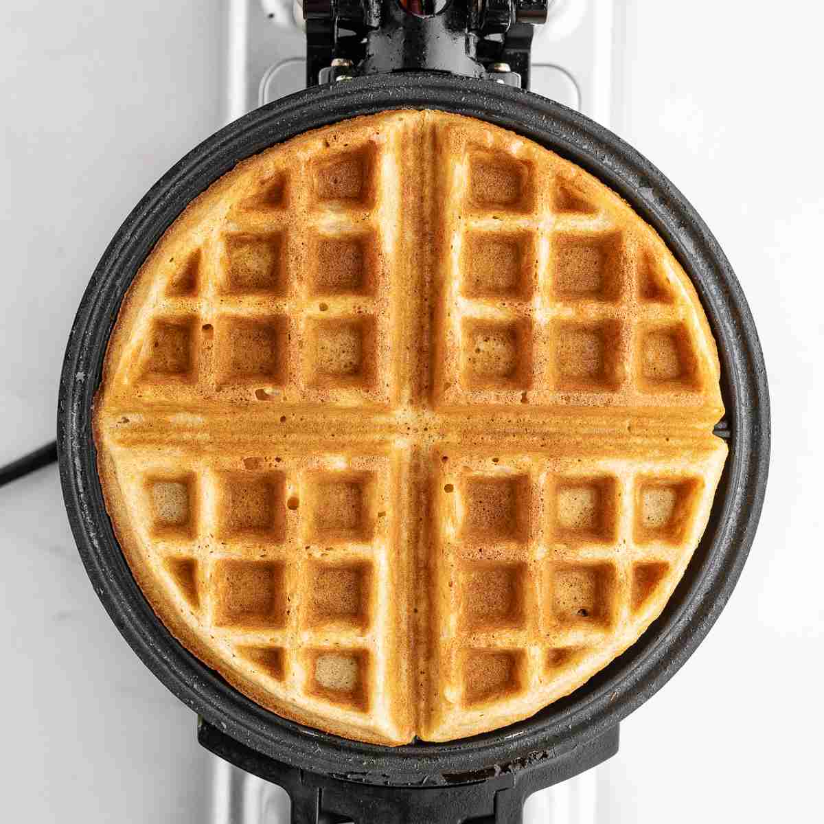 waffle iron with cooked fresh milled flour waffle