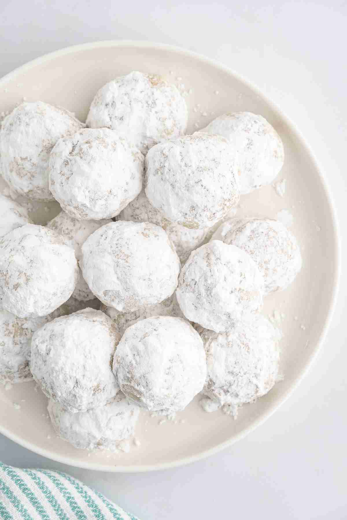  a plate of fresh milled mexican wedding cookies also called pecan snowballs seen from overhead