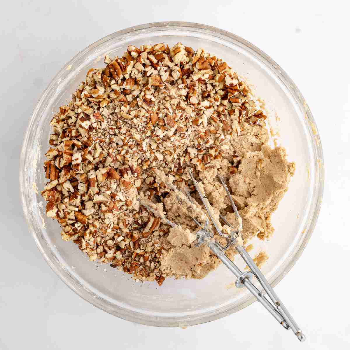 mixing bowl showing nuts added to dough for fresh milled mexican wedding cookies