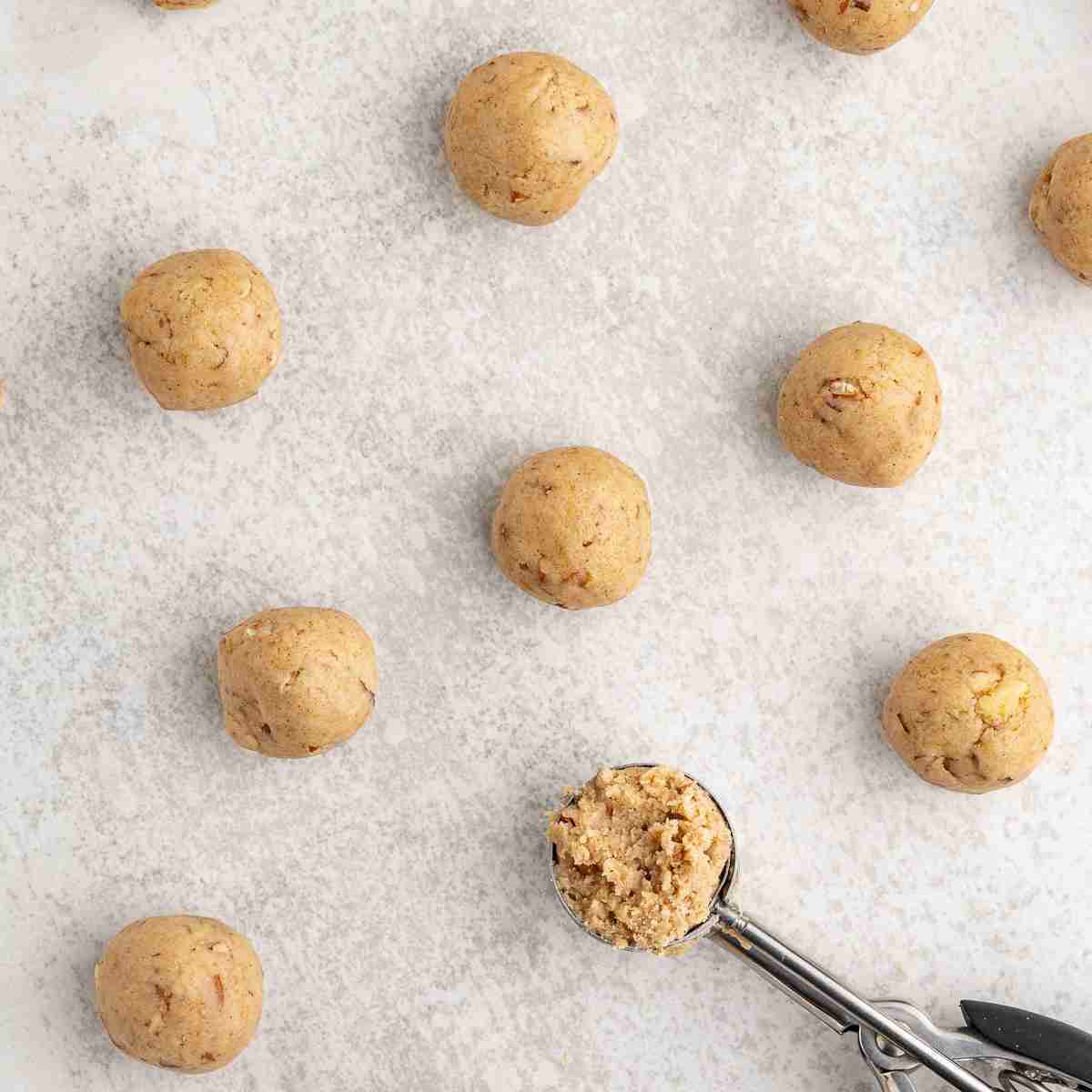 small balls of fresh milled mexican wedding cookies on baking tray before baking