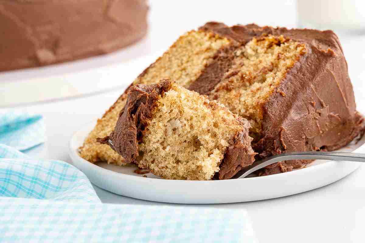 a slice of fresh milled yellow cake on plate with bite shot