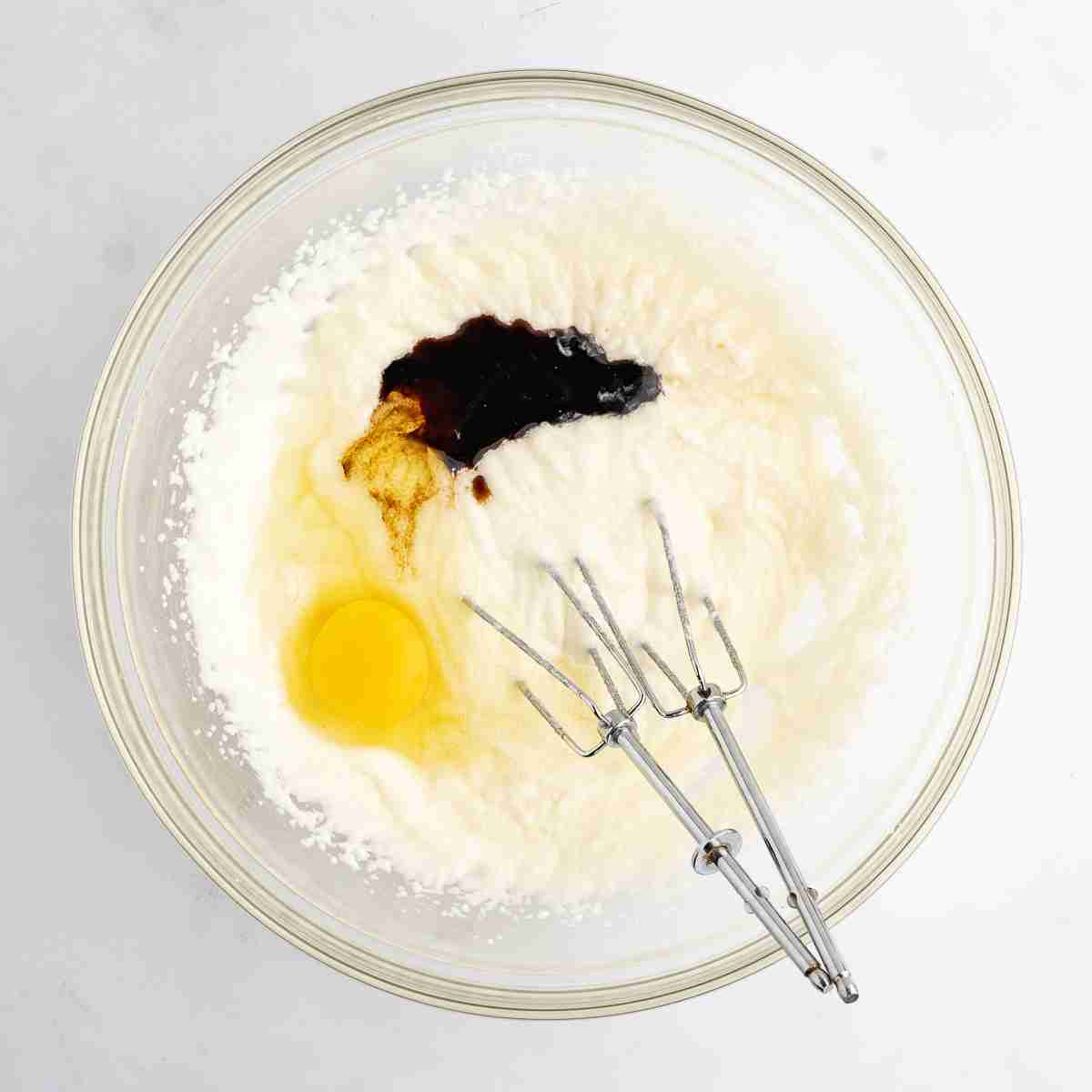 mixing bowl showing egg and vanilla added