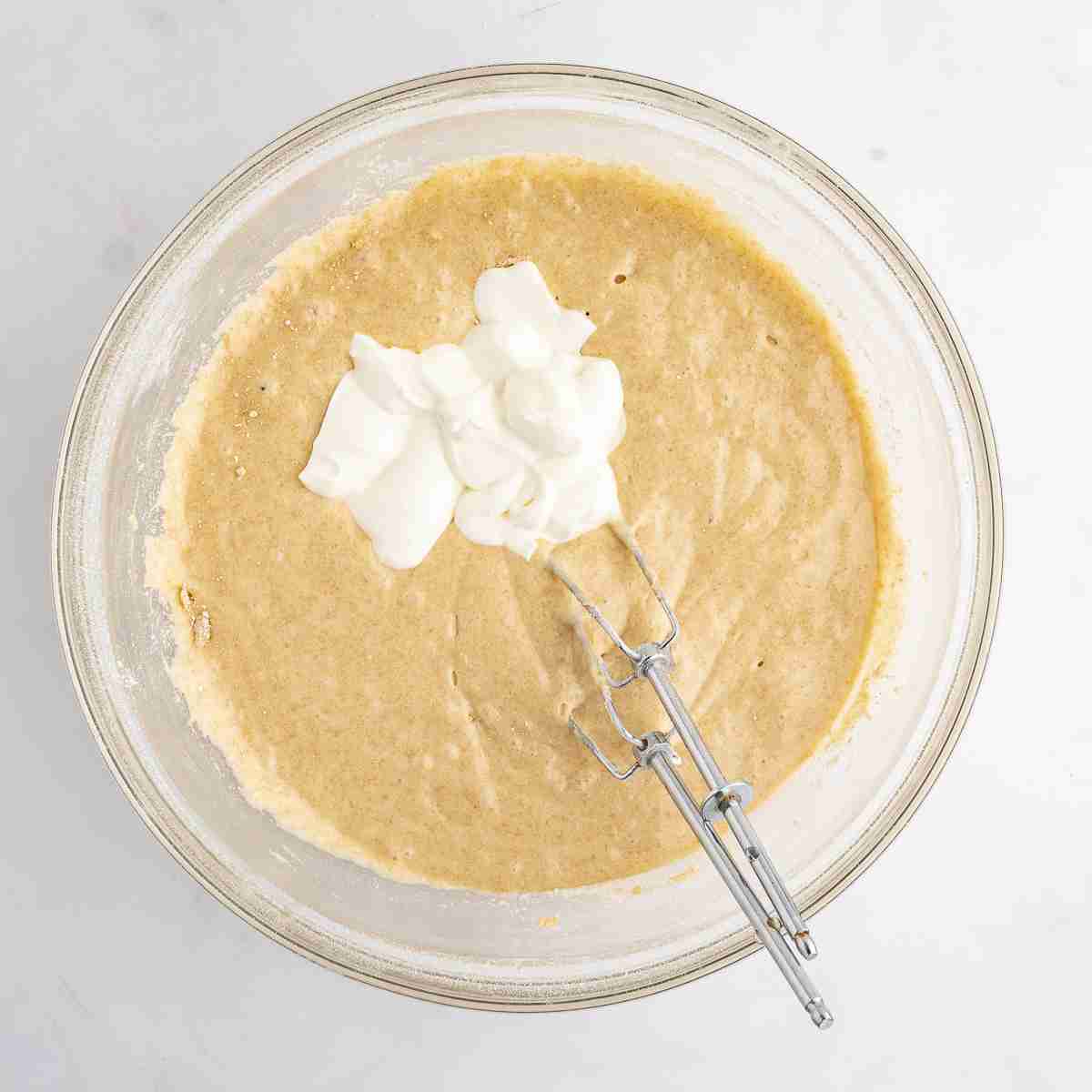 mixing bowl showing sour cream added to fresh milled cake batter