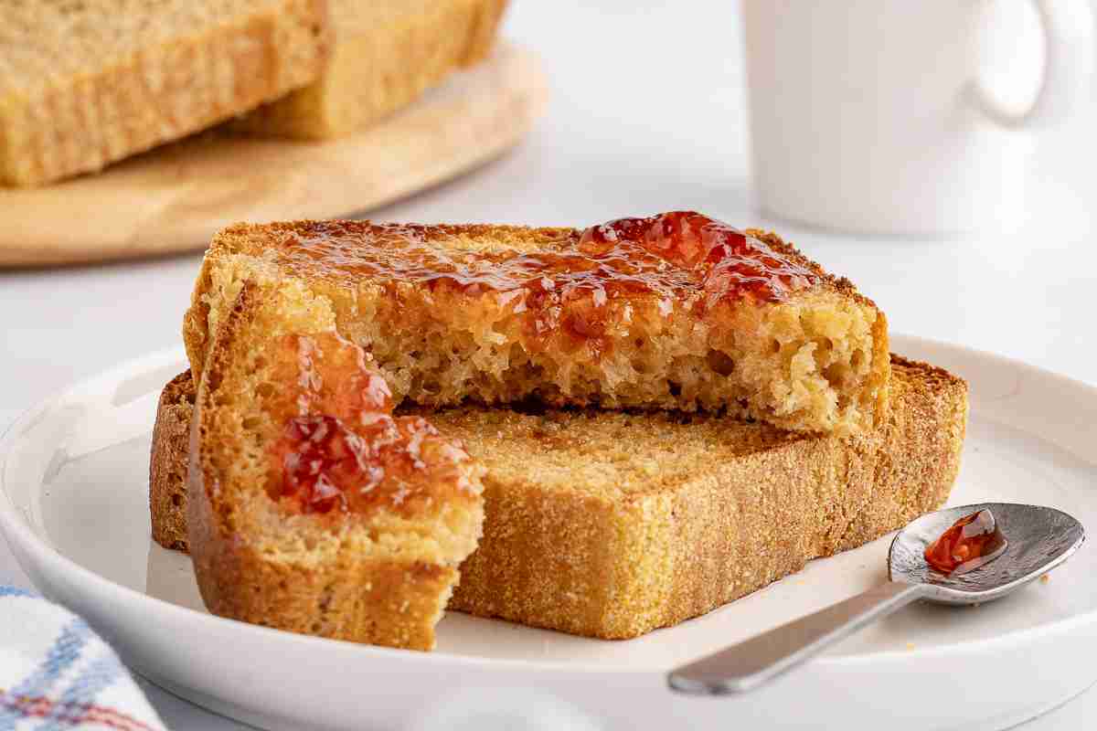 two pieces of fresh milled English muffin toast with butter and jelly