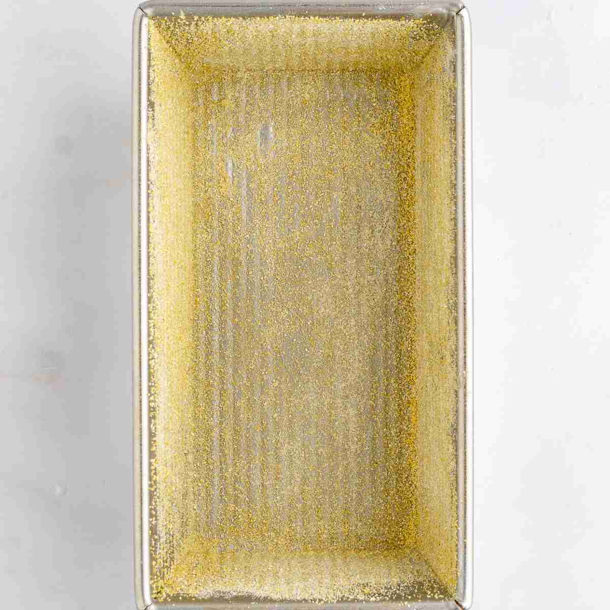 baking pan greased and sprinkled with cornmeal ready for fresh milled English muffin toasting bread dough