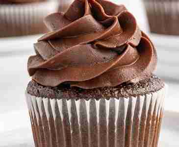 a single fresh milled chocolate cupcake with chocolate frosting