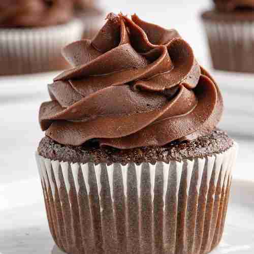 a single fresh milled chocolate cupcake with chocolate frosting